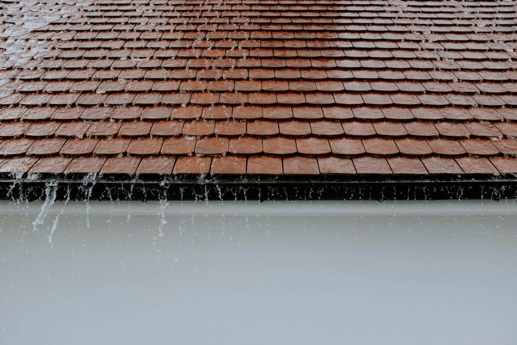 Heavy rainfall cascading off the roof