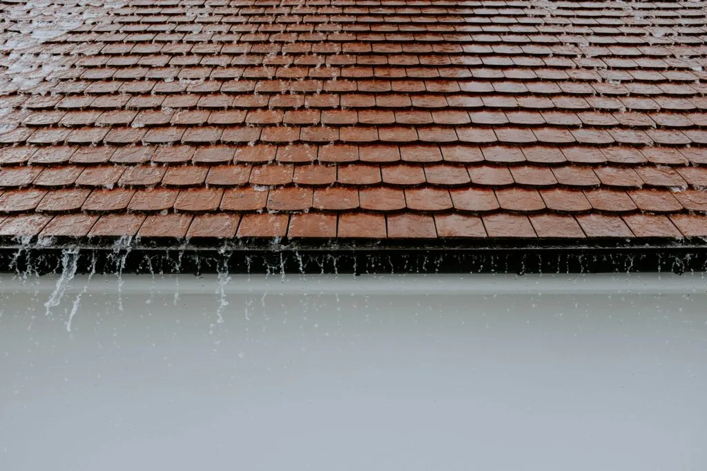 Heavy rainfall cascading off the roof