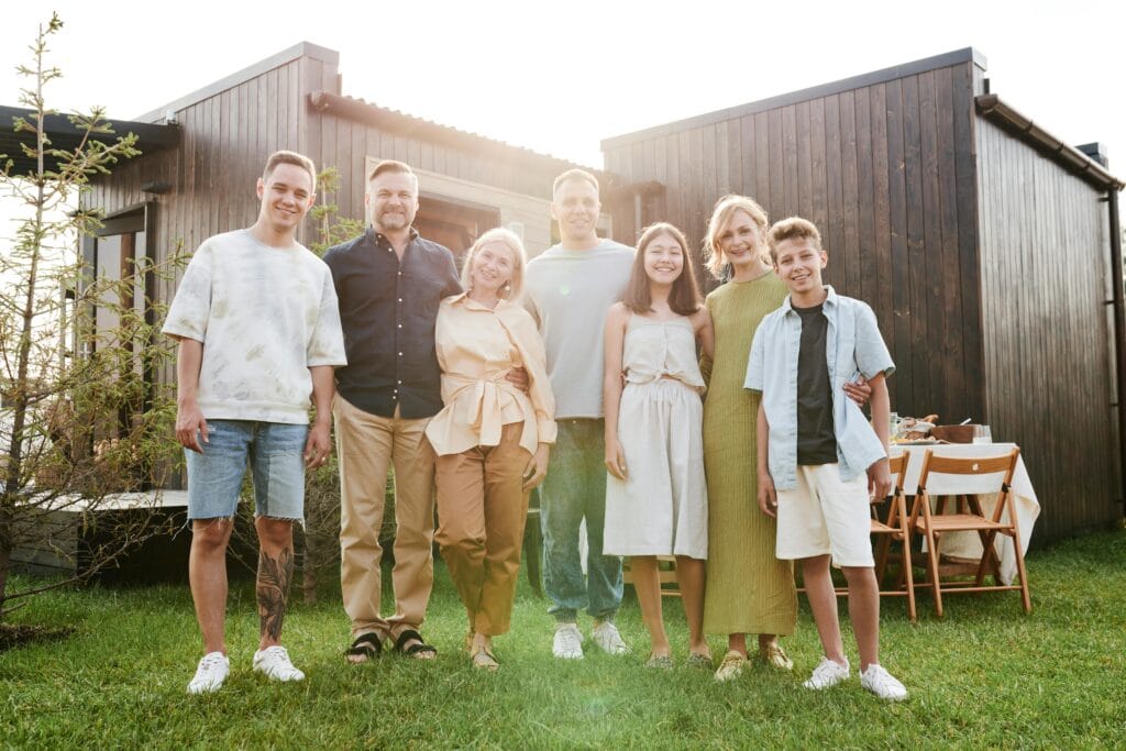 Family enjoying a backyard barbecue while following safety precautions, highlighting the importance of protecting your home from fire and smoke risks.
