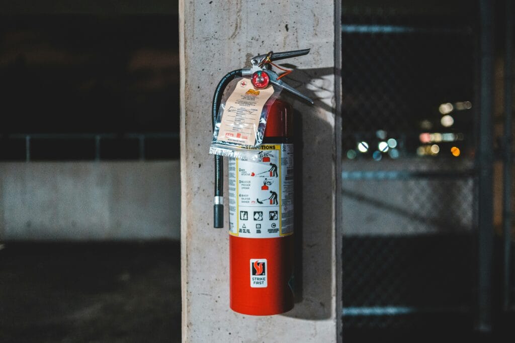 Red fire extinguisher mounted on a wall