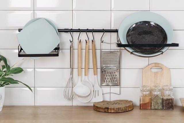 A kitchen counter with utensils and plates
