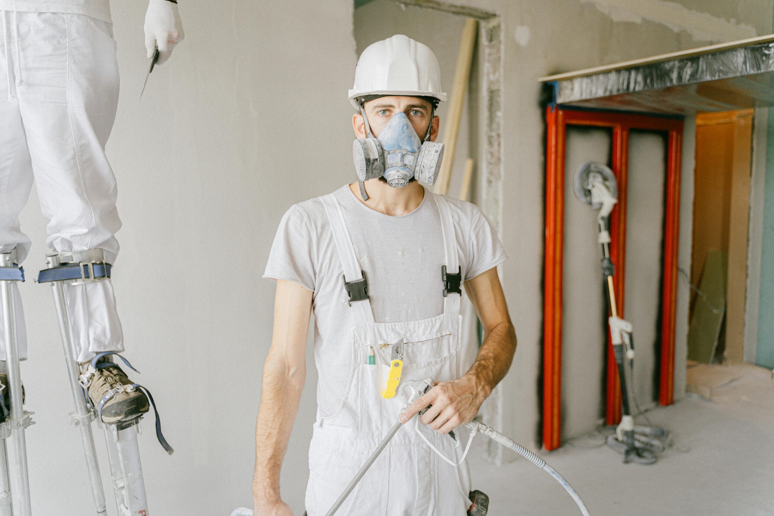 Man in a white crew neck t-shirt wearing a mask